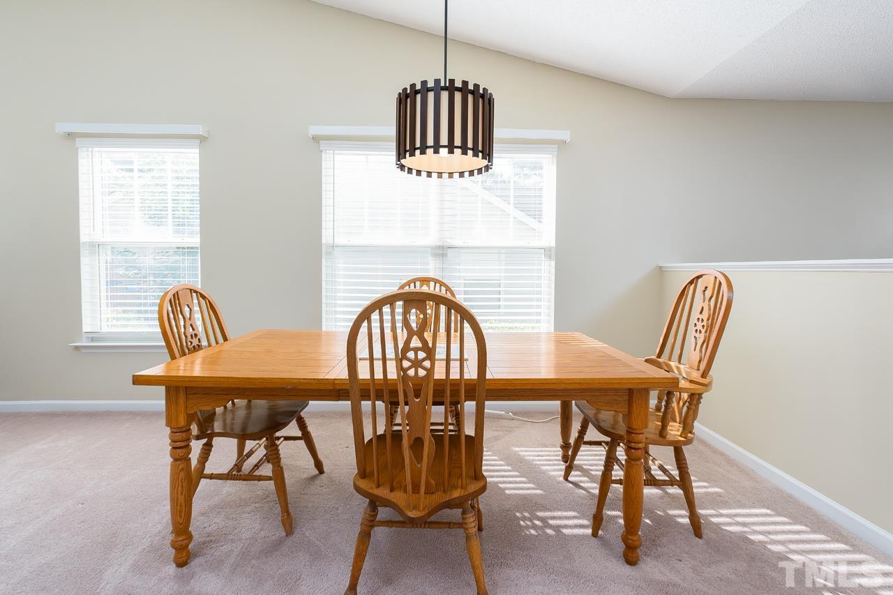 3815 Hopper Street Raleigh, NC 27616 - Photo 4 of 18 a view of a dining room with furniture window and wooden floor