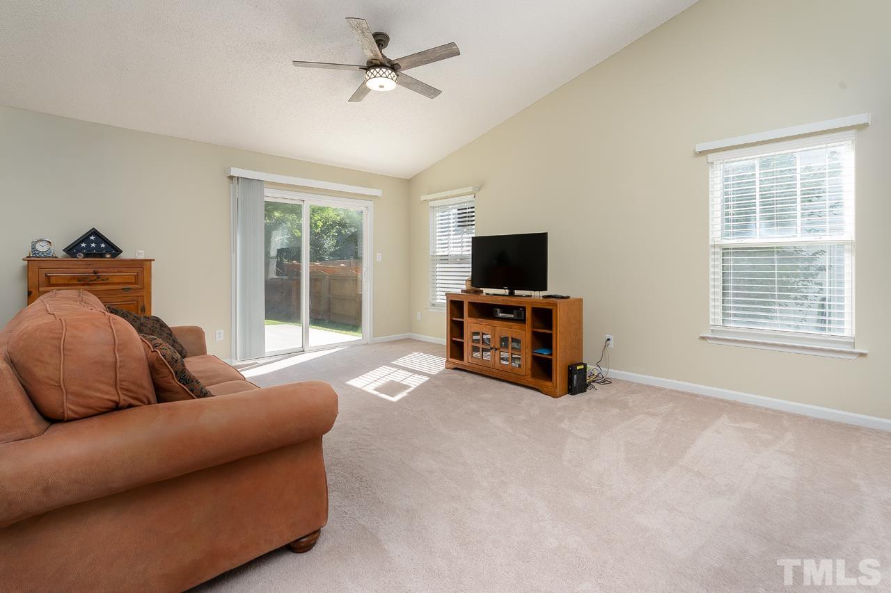 3815 Hopper Street Raleigh, NC 27616 - Photo 5 of 18 a bedroom with furniture and a flat screen tv
