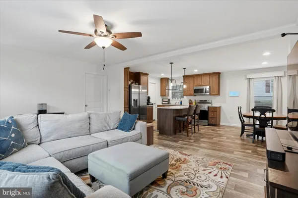 a living room with furniture kitchen view and a dining table