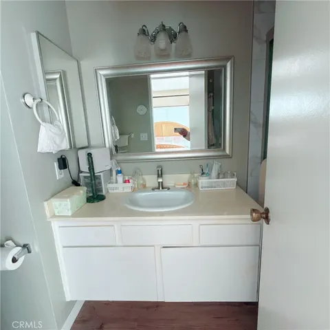 a bedroom with a bed and a lamp on dresser