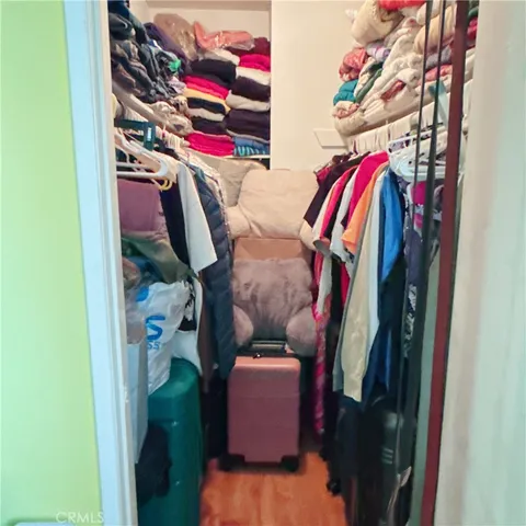 a bedroom with a bed and flat screen tv