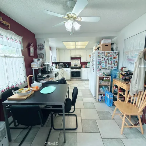 a view of a dining room with furniture and a chandelier