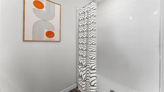 a bathroom with a shower and mirror