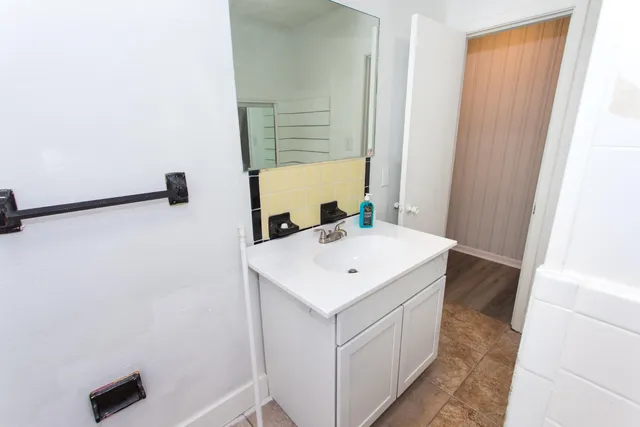 a view of bathroom with a sink and mirror