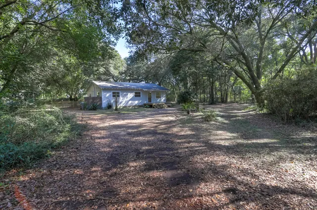 a view of house with outdoor space and garden