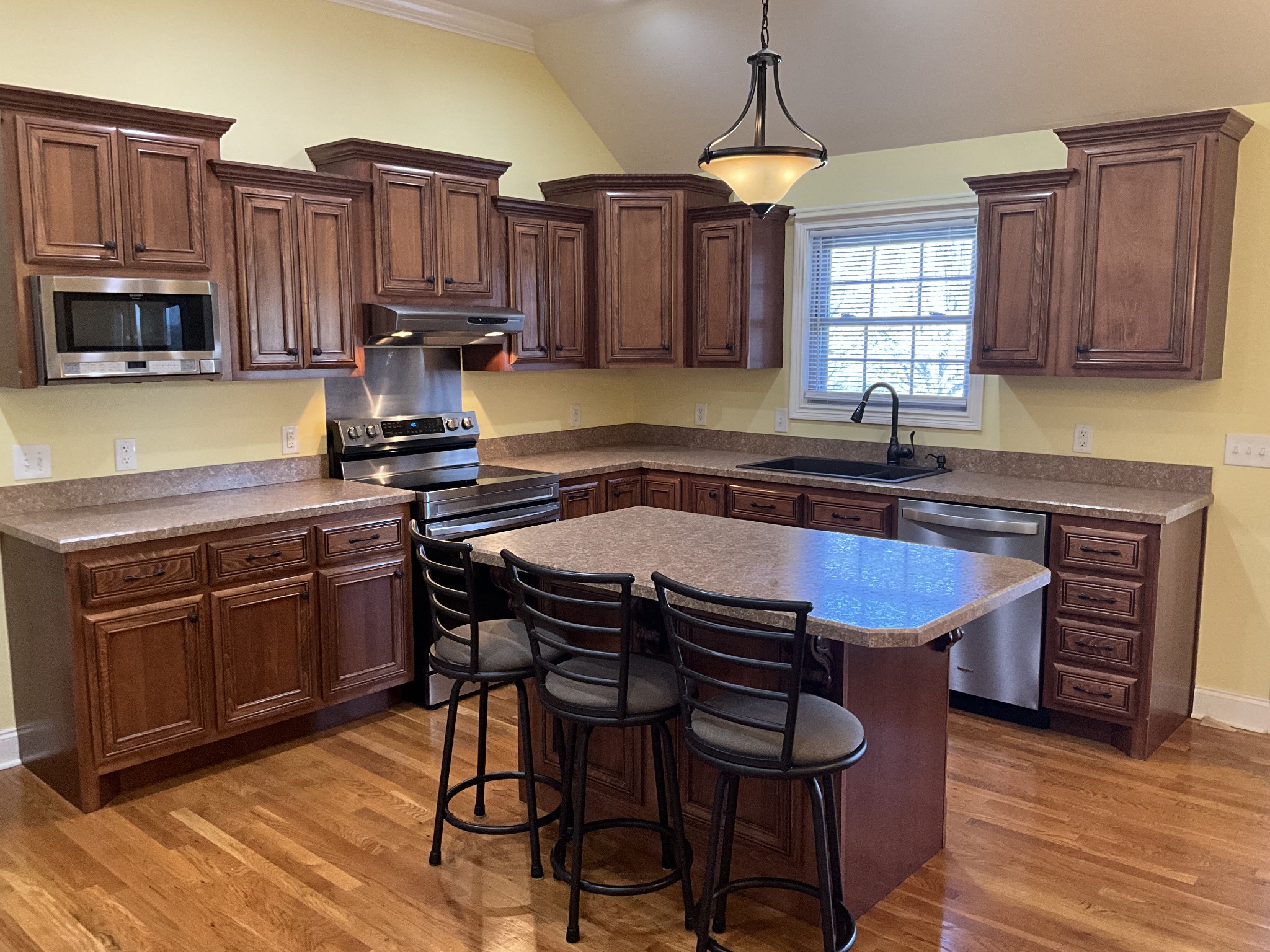 2511 Chambliss Road Pleasant View, TN 37146 - Photo 4 of 24 a kitchen with stainless steel appliances granite countertop wooden cabinets a stove a sink and a microwave