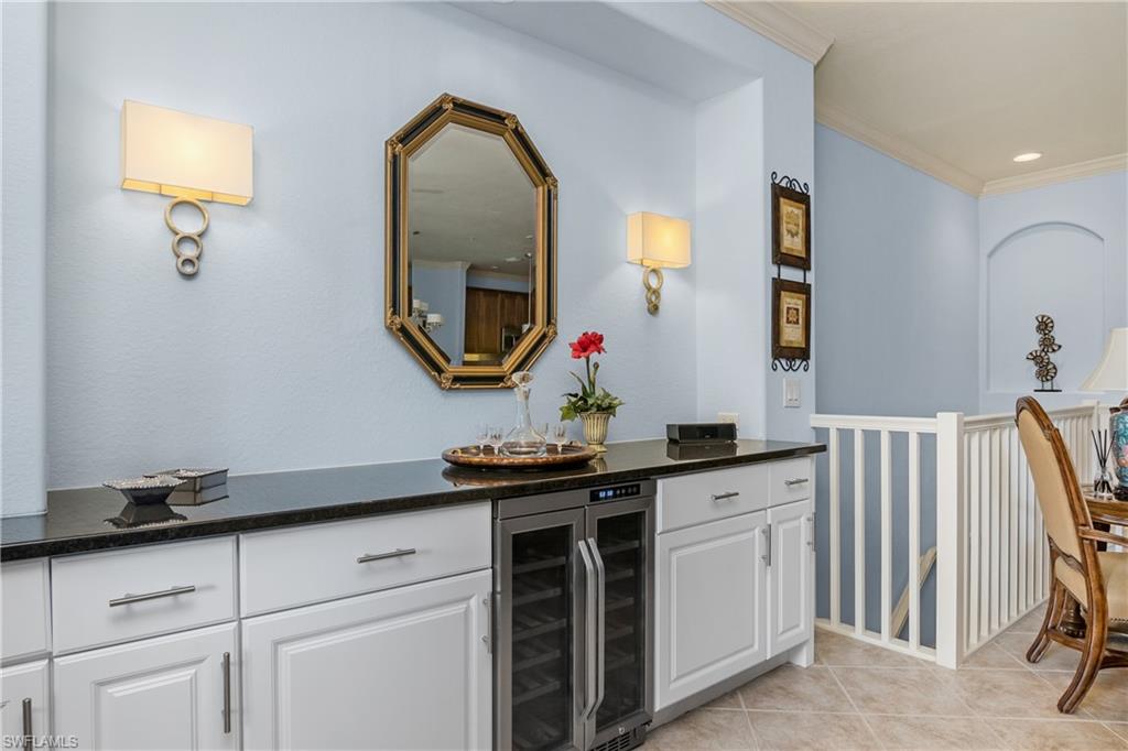 9108 Capistrano Street South, Unit 7402 Naples, FL 34113 - Photo 11 of 50 a bathroom with a sink and a mirror