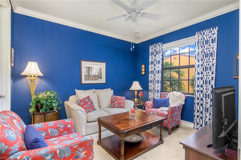 9108 Capistrano Street South, Unit 7402 Naples, FL 34113 - Photo 26 of 50 a living room with furniture and a flat screen tv