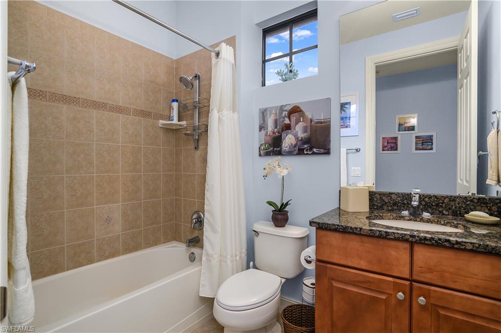9108 Capistrano Street South, Unit 7402 Naples, FL 34113 - Photo 28 of 50 a bathroom with a toilet a sink and bathtub