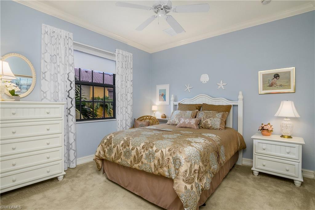 9108 Capistrano Street South, Unit 7402 Naples, FL 34113 - Photo 29 of 50 a bedroom with a bed and a dresser
