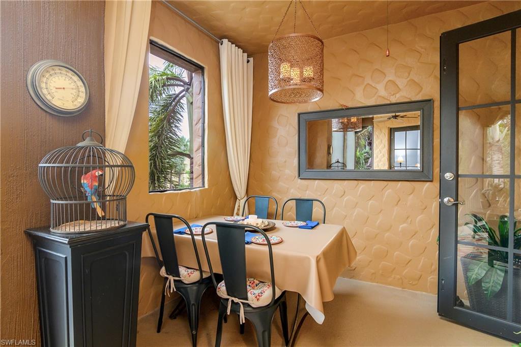 9108 Capistrano Street South, Unit 7402 Naples, FL 34113 - Photo 33 of 50 a view of a dining room with furniture window and wooden floor