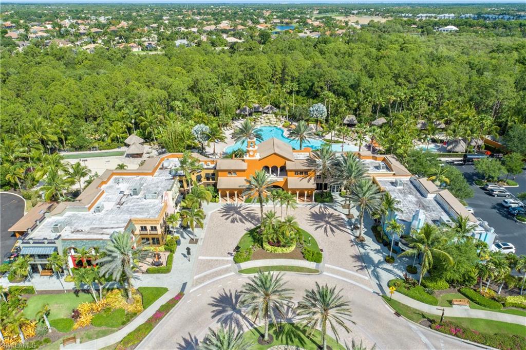 9108 Capistrano Street South, Unit 7402 Naples, FL 34113 - Photo 38 of 50 an aerial view of residential houses with outdoor space and trees
