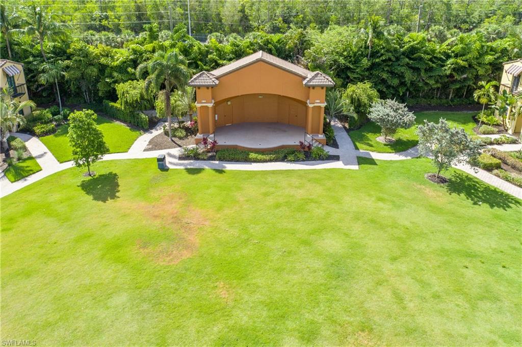 9108 Capistrano Street South, Unit 7402 Naples, FL 34113 - Photo 47 of 50 a view of a garden with a slide