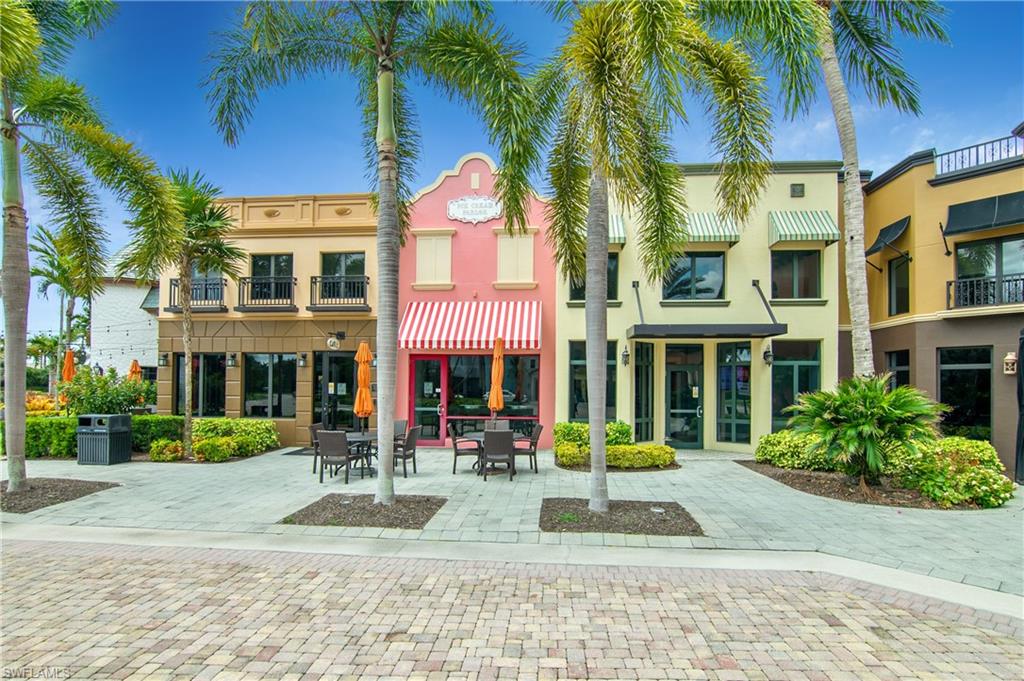 9108 Capistrano Street South, Unit 7402 Naples, FL 34113 - Photo 50 of 50 a view of a building with a yard and palm trees