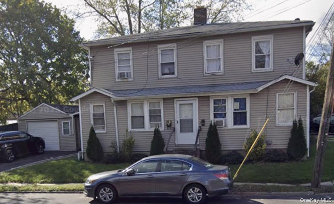 311 Nassau Road Huntington, NY 11746 - Photo 1 of 3 a front view of a house with a garden