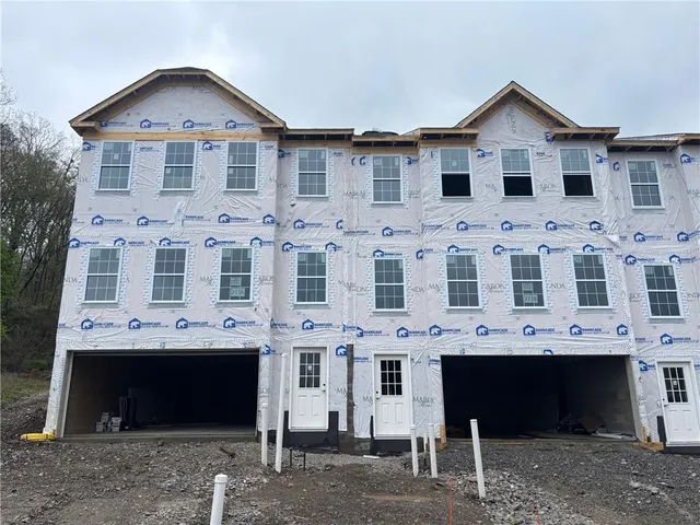 a view of a white building with large windows