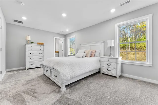 a bedroom with a large bed and a flat screen tv