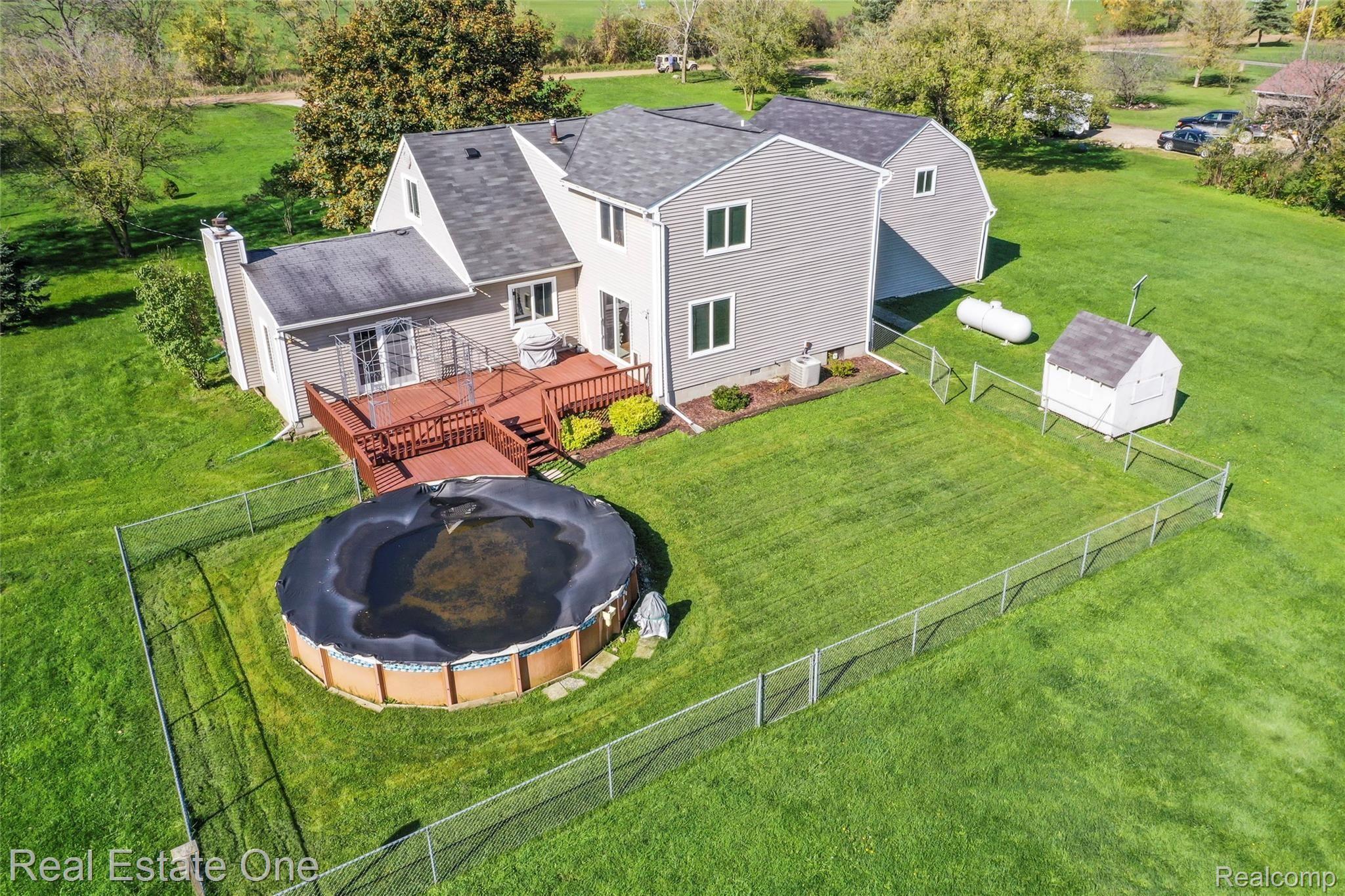 8120 Green Road Fenton, MI 48430 - Photo 6 of 46 Large pool for summer entertaining. Door wall off family room and Kitchen to large deck. New pool equipment ready to go for next spring.