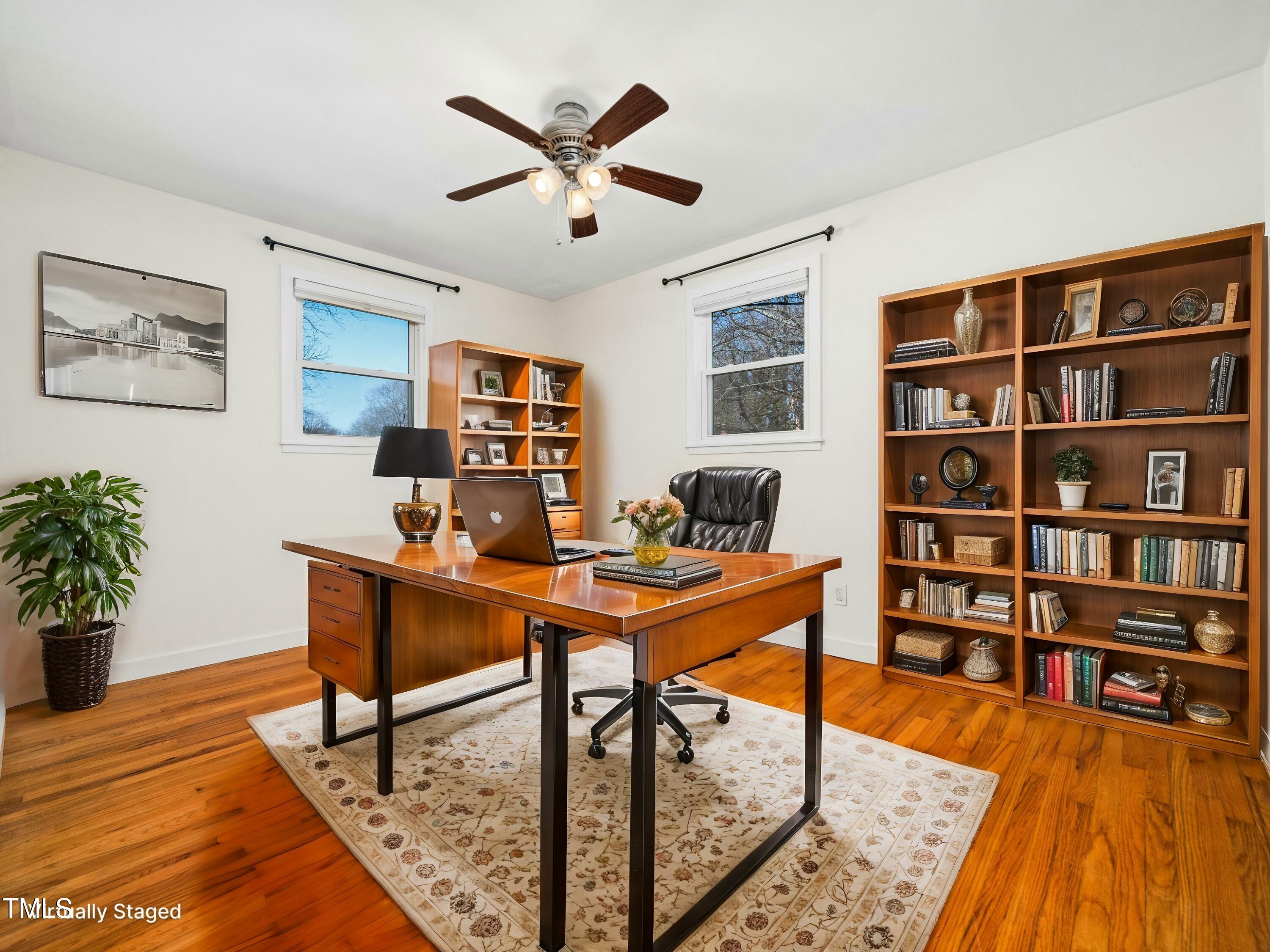 2011 Watkins Street Raleigh, NC 27604 - Photo 12 of 36 a view of a workspace with furniture and bookshelf