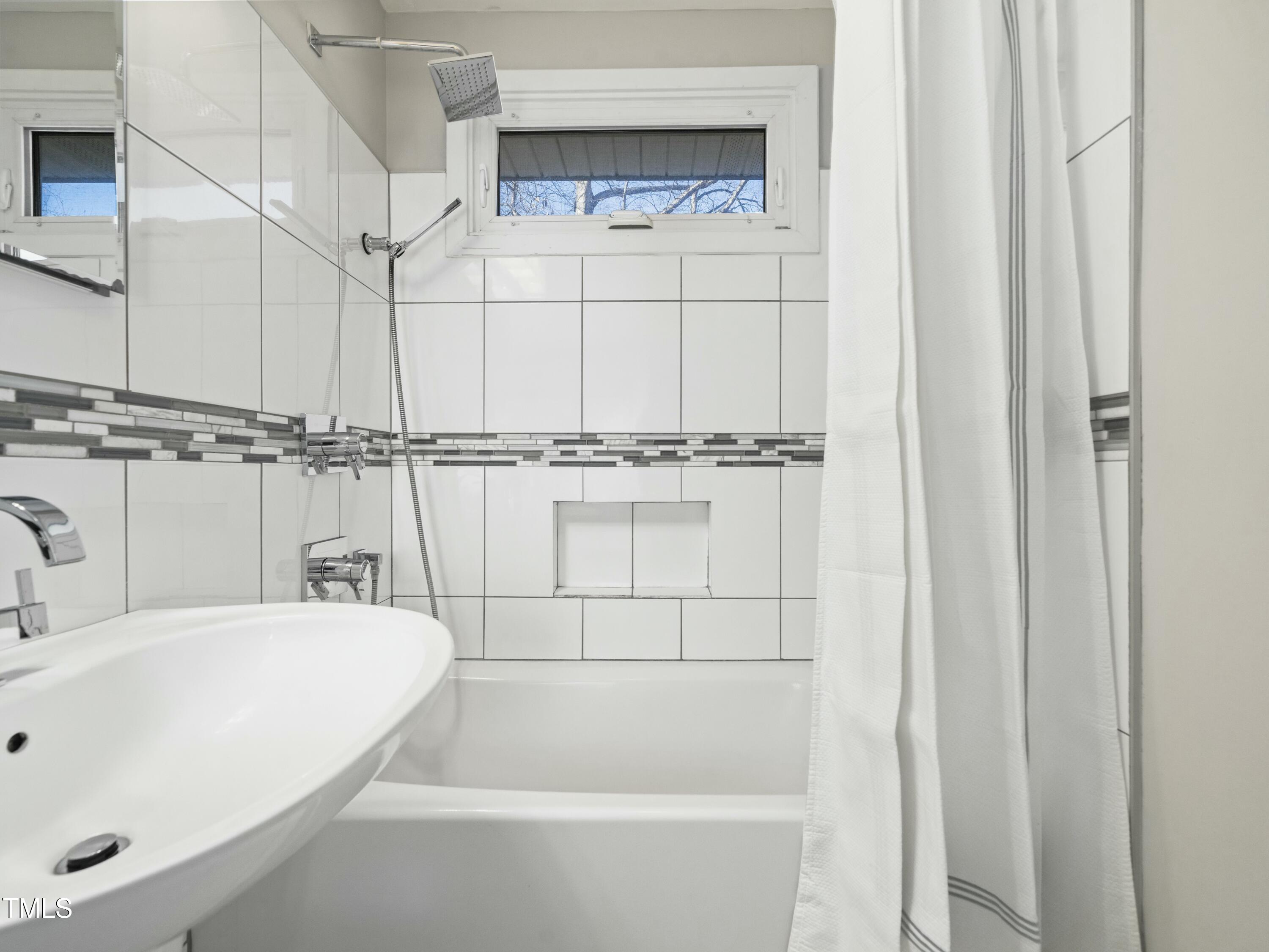 2011 Watkins Street Raleigh, NC 27604 - Photo 18 of 36 a bathroom with bathtub and shower