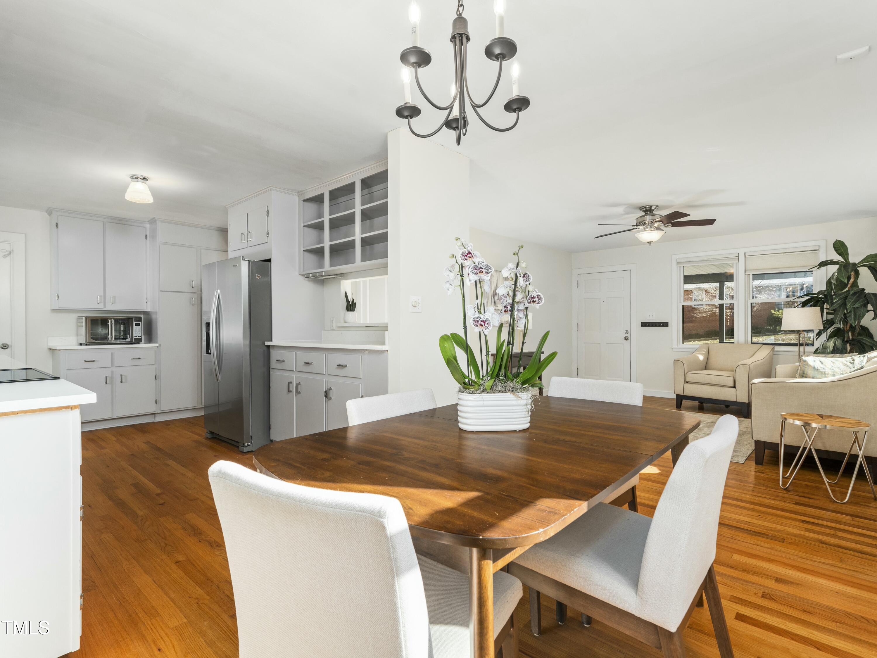 2011 Watkins Street Raleigh, NC 27604 - Photo 5 of 36 a dining room with wooden floor a glass table and chairs