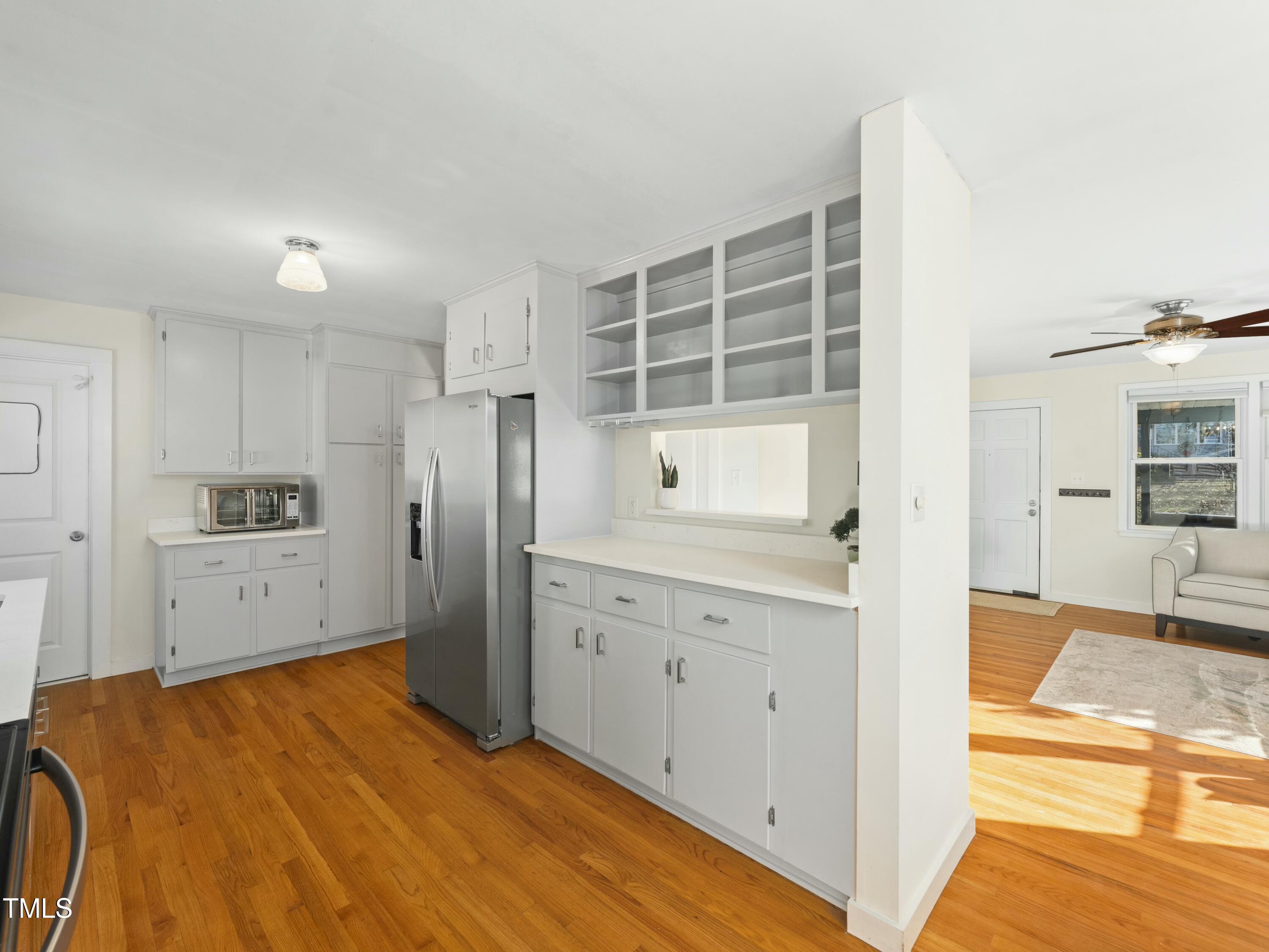 2011 Watkins Street Raleigh, NC 27604 - Photo 6 of 36 a kitchen with stainless steel appliances kitchen island granite countertop a refrigerator and cabinets