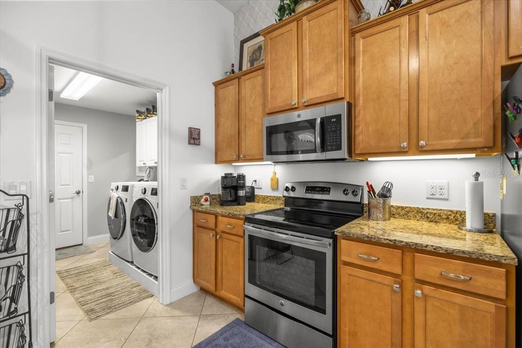 9957 Southwest 55th Ave Road Ocala, FL 34476 - Photo 11 of 41 a view of a storage and utility room with washer and dryer