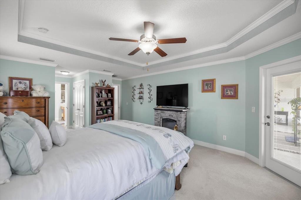 9957 Southwest 55th Ave Road Ocala, FL 34476 - Photo 15 of 41 a bedroom with a bed and a flat screen tv