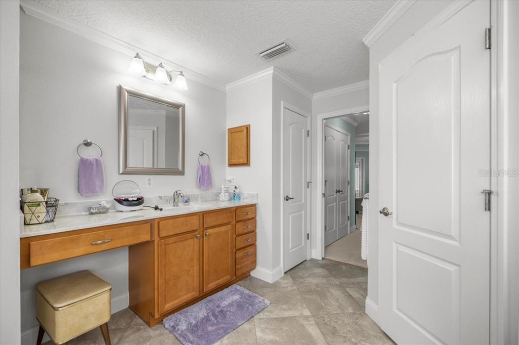 9957 Southwest 55th Ave Road Ocala, FL 34476 - Photo 18 of 41 a bathroom with a double vanity sink mirror and bathtub