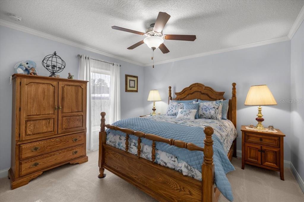 9957 Southwest 55th Ave Road Ocala, FL 34476 - Photo 21 of 41 a bedroom with a bed and a lamp on the dresser