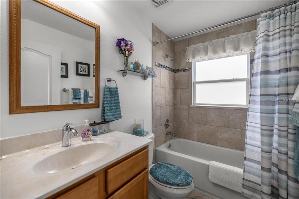 9957 Southwest 55th Ave Road Ocala, FL 34476 - Photo 23 of 41 a bathroom with a sink mirror toilet and bathtub