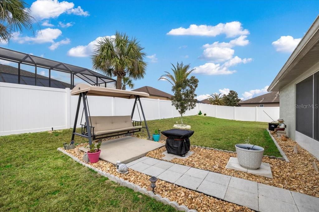9957 Southwest 55th Ave Road Ocala, FL 34476 - Photo 27 of 41 a backyard of a house with table and chairs