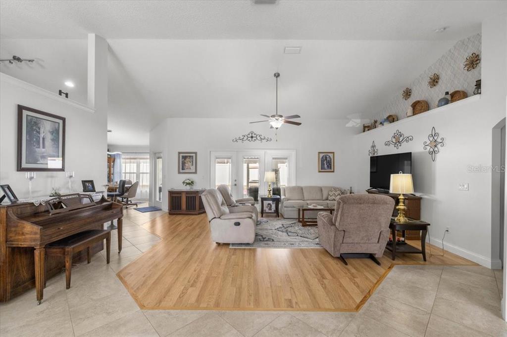 9957 Southwest 55th Ave Road Ocala, FL 34476 - Photo 3 of 41 a living room with fireplace furniture and a chandelier