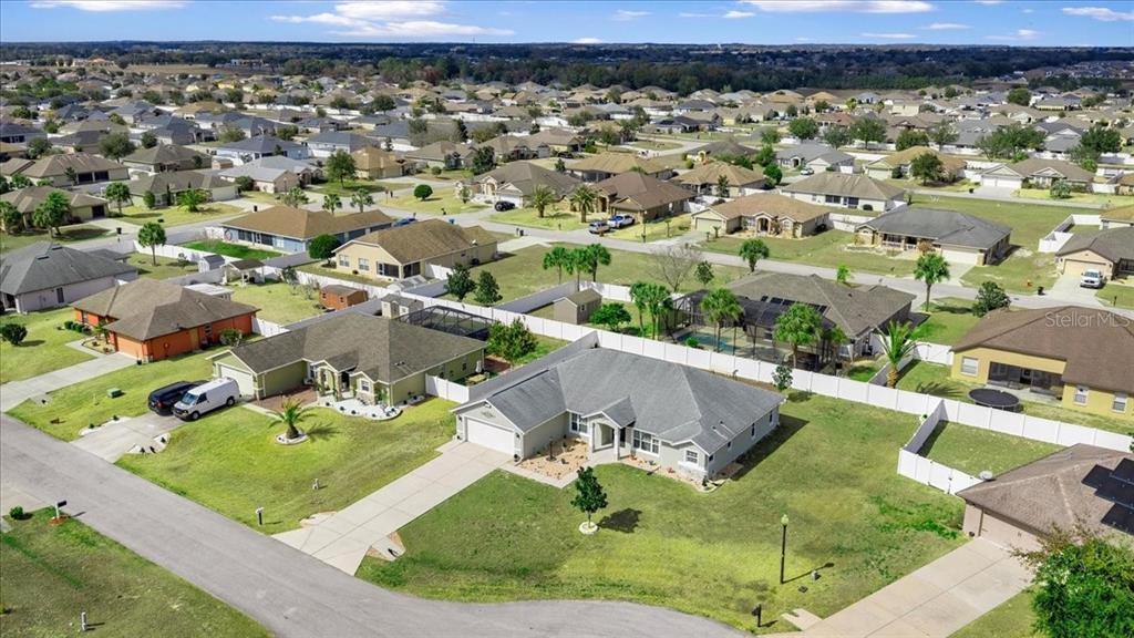 9957 Southwest 55th Ave Road Ocala, FL 34476 - Photo 32 of 41 an aerial view of a house with a garden and lake view