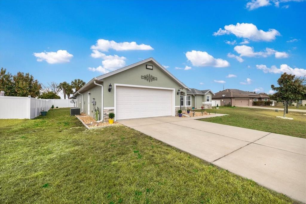 9957 Southwest 55th Ave Road Ocala, FL 34476 - Photo 37 of 41 a front view of a house with a yard