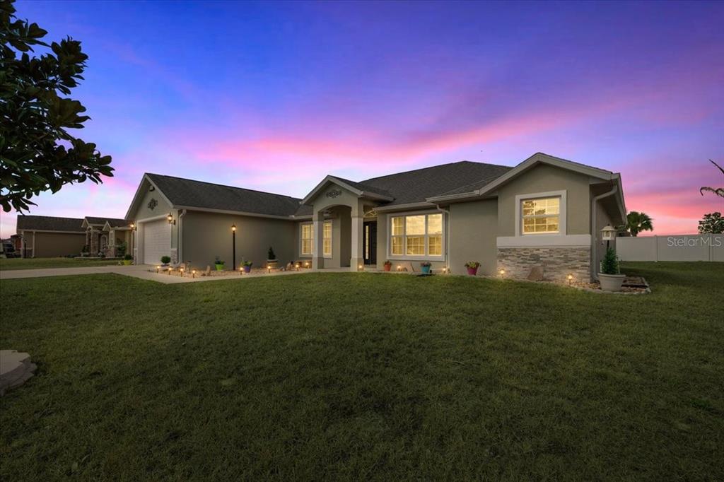 9957 Southwest 55th Ave Road Ocala, FL 34476 - Photo 40 of 41 a front view of a house with a garden