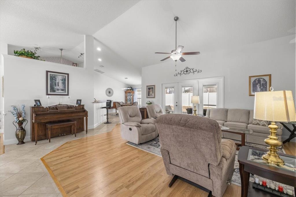 9957 Southwest 55th Ave Road Ocala, FL 34476 - Photo 4 of 41 a living room with furniture a fireplace and a flat screen tv
