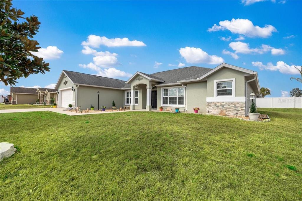 9957 Southwest 55th Ave Road Ocala, FL 34476 - Photo 41 of 41 a front view of house with yard and green space