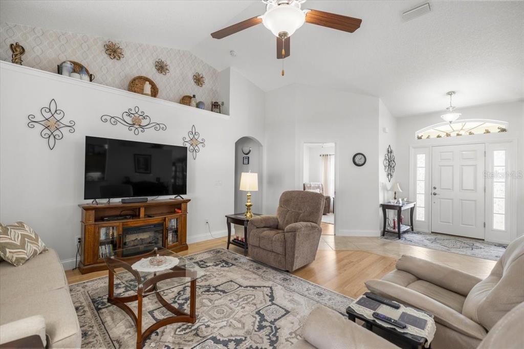 9957 Southwest 55th Ave Road Ocala, FL 34476 - Photo 5 of 41 a living room with furniture and a flat screen tv