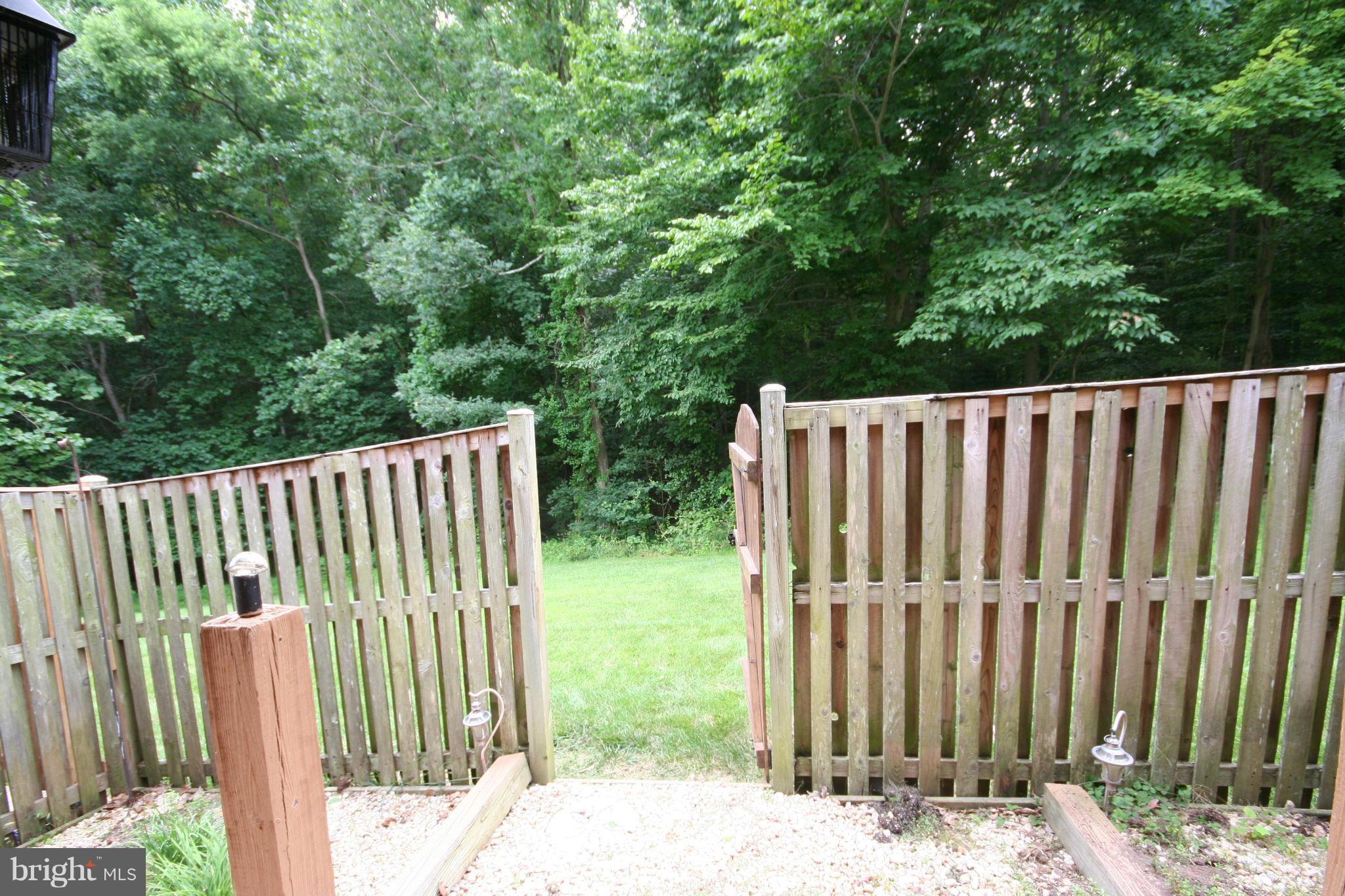 7467 Ridge Oak Court Springfield, VA 22153 - Photo 22 of 24 Fenced yard w/flower beds opens to parkland