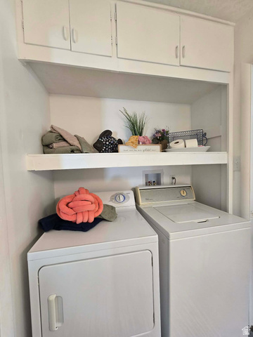 259 14th Street Ogden, UT 84404 - Photo 20 of 21 Dedicated laundry area featuring a built-in upper cabinet system and an integrated shelf for practical storage solutions