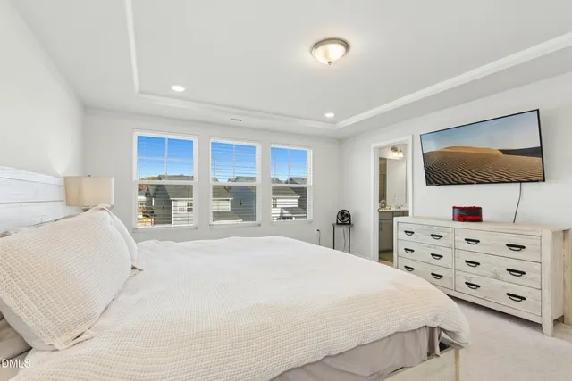 a bedroom with a bed and flat screen tv