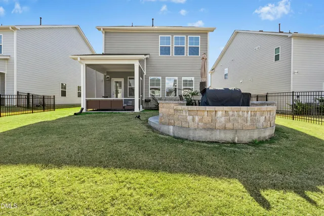 a view of a house with patio and a yard