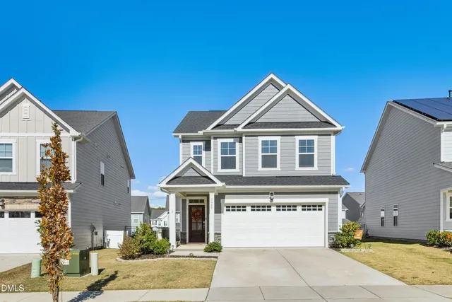 a front view of a house with a yard and garage
