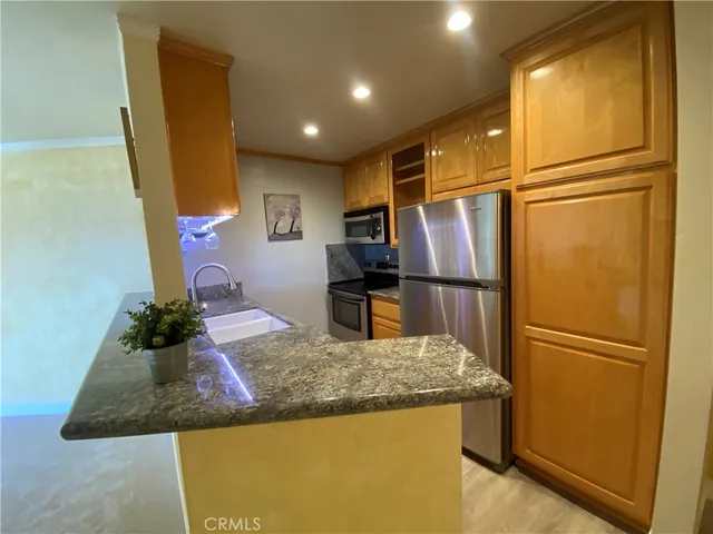 a kitchen with a refrigerator and a sink