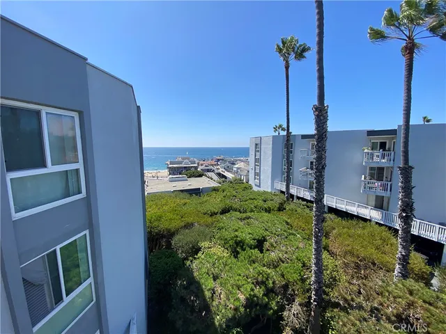 a view of a garden with a building in the background