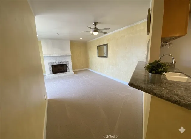 a kitchen with granite countertop a sink toilet and cabinets