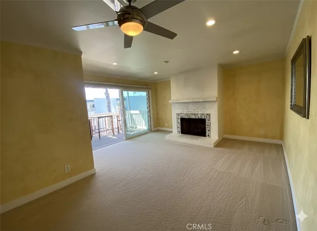 an empty room with a fireplace and fan