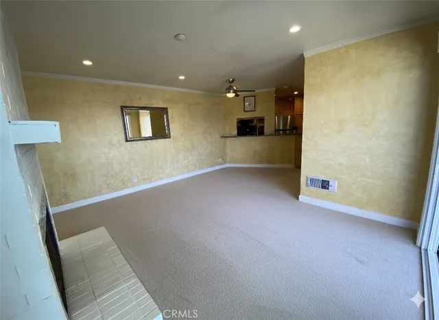 an empty room with cabinet and mirrors