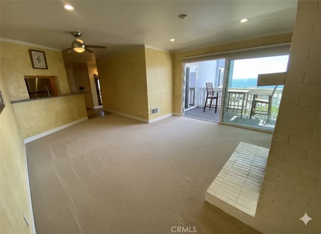 a view of an empty room with a fireplace